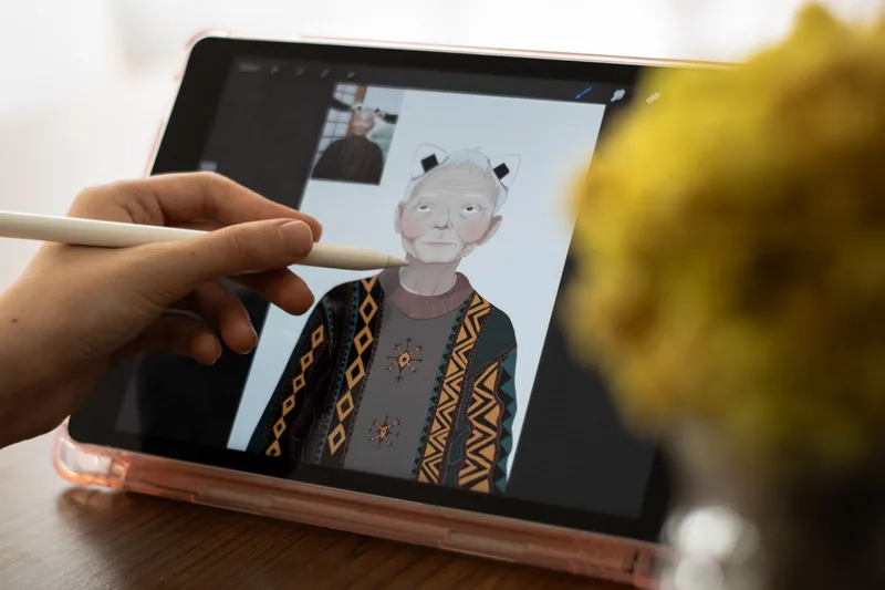 Artist drawing on a tablet with stylus, creating digital concept art