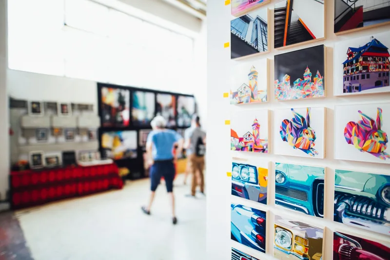 Framed photography and art prints displayed on a minimalist gallery wall