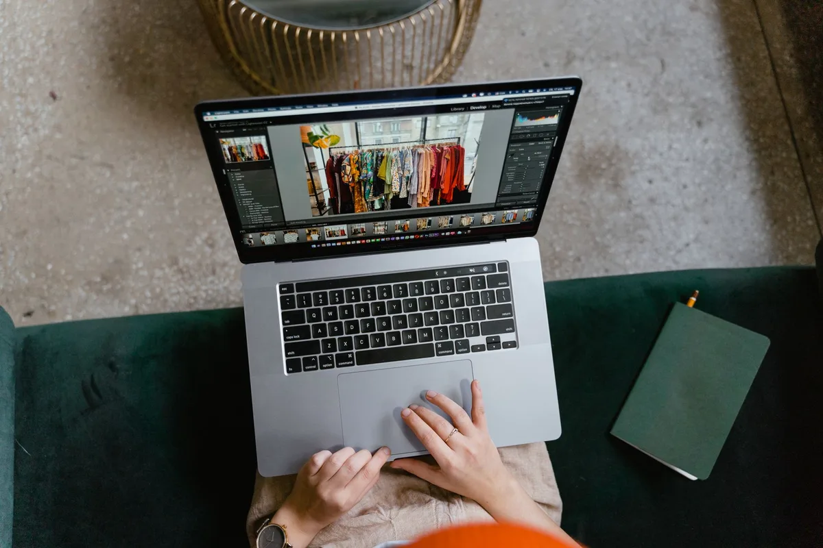 Person working on a laptop managing an online business selling digital products