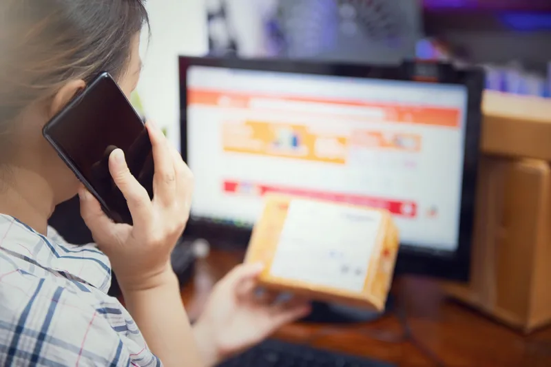 A person reviewing digital products on a laptop, comparing platform options and listings