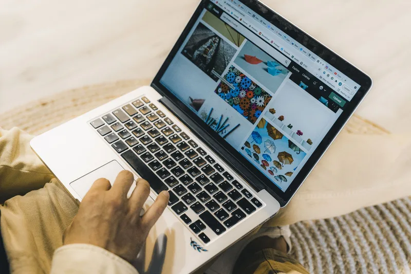 Person designing a printable worksheet in Canva on a laptop
