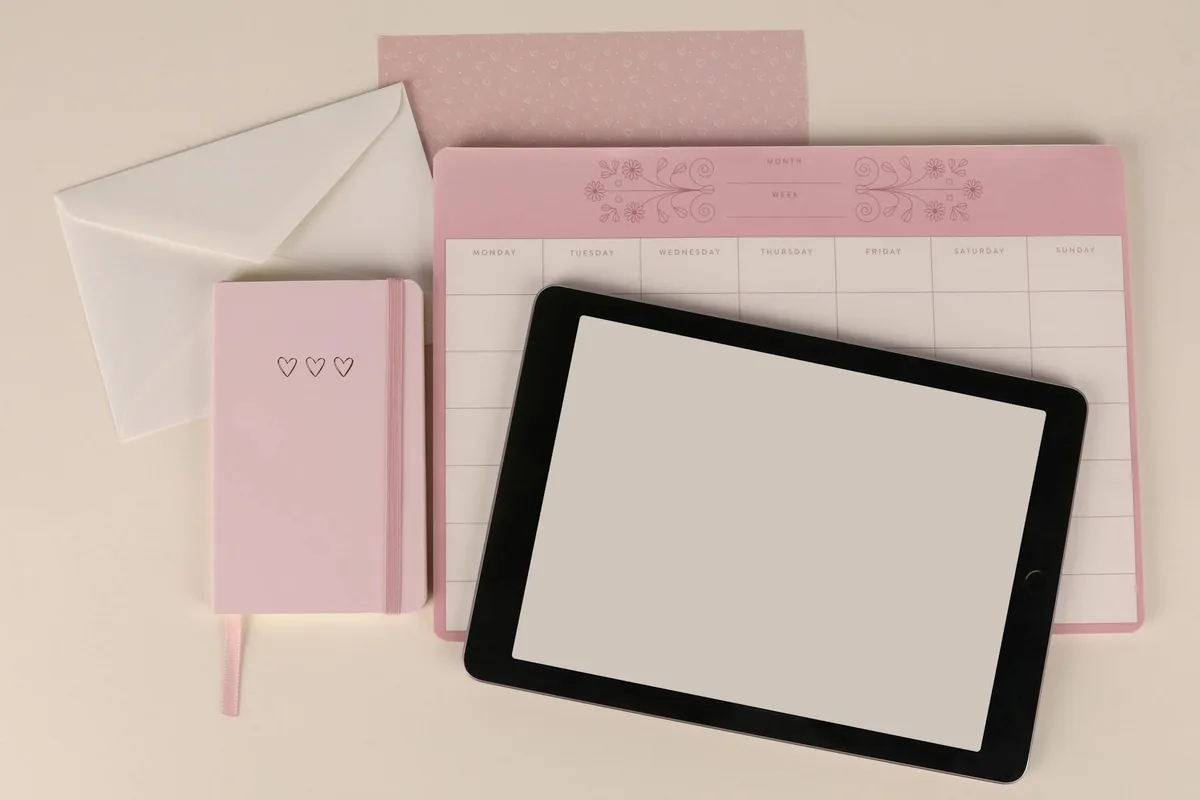 A collection of printable planner pages and digital download products arranged on a wooden desk