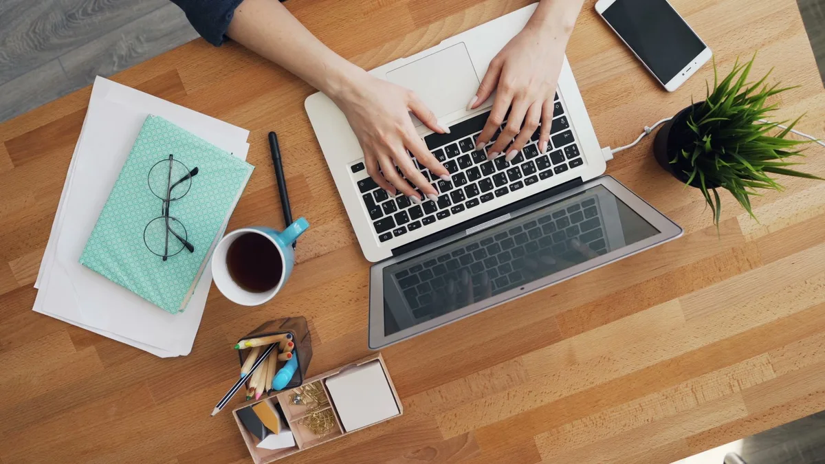 Aerial view of a laptop and coffee on a home office desk